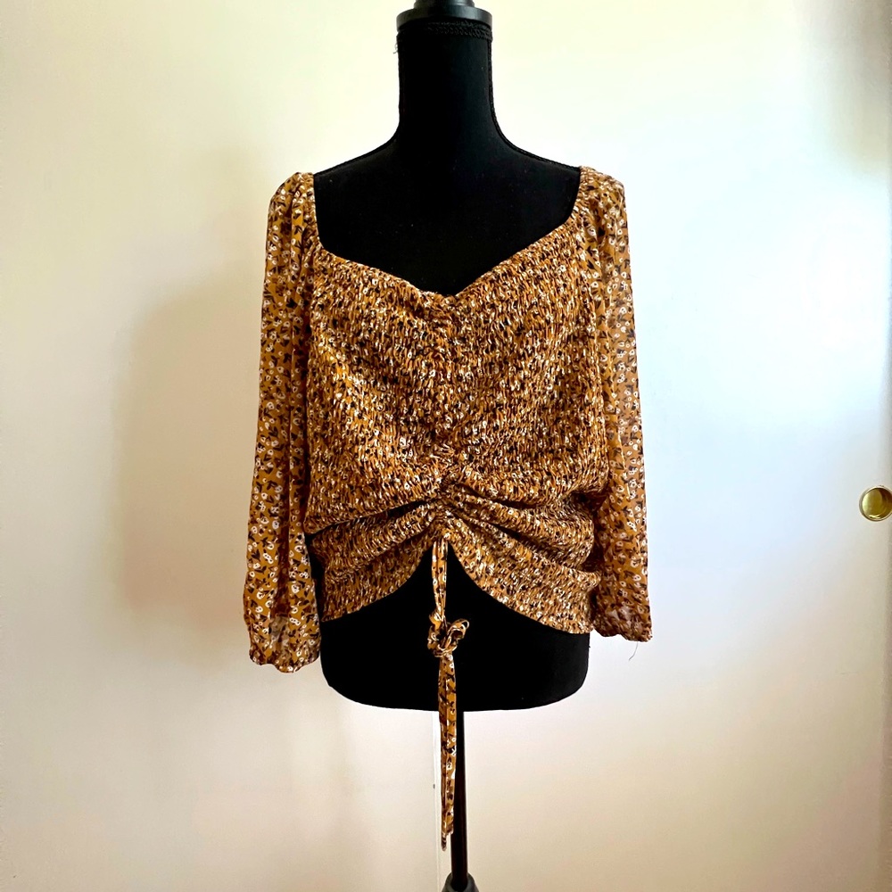 Tan flower blouse.